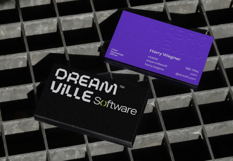 Dream Ville Software business cards photographed on a metal grid