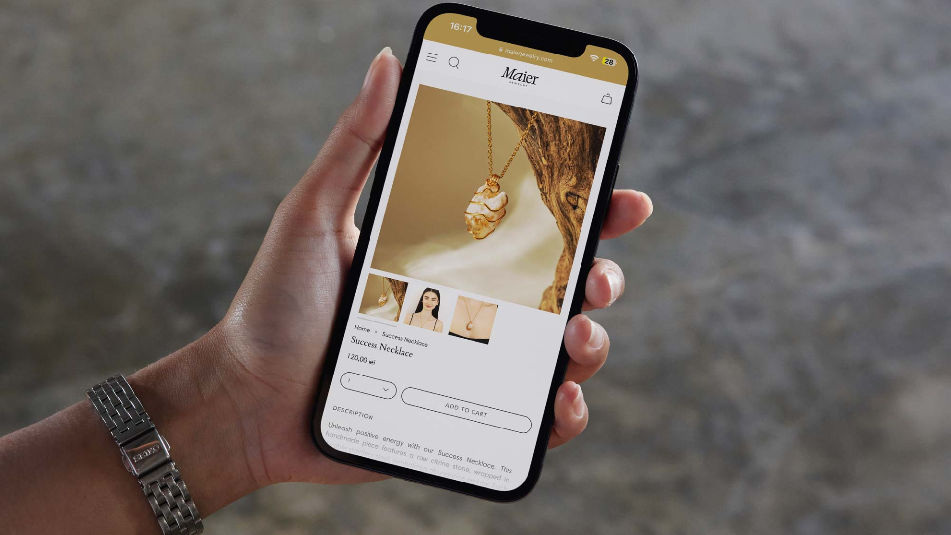Maier Jewelry online shop displayed on a phone held in one hand