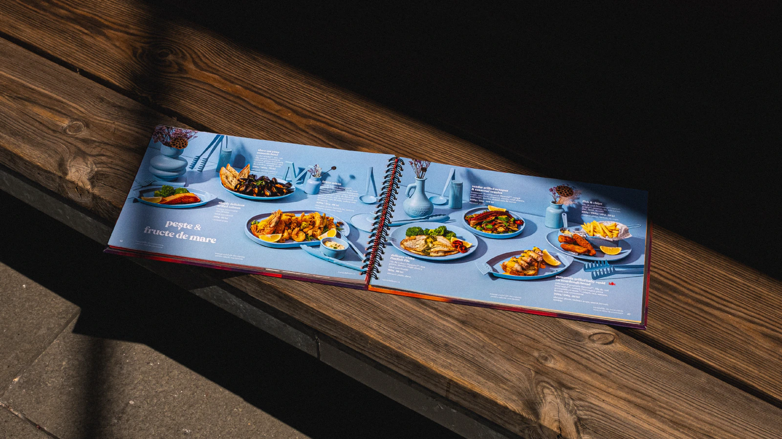 Open Marty Restaurants menu displaying plated dishes on a wooden bench